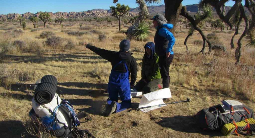 a group of veterans practice navigation on an outward bound veterans course